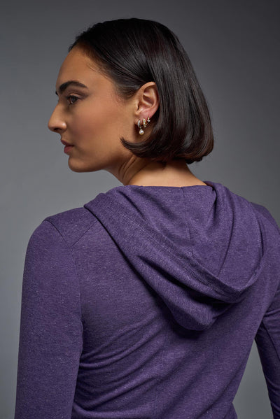 A female model wearing the women's Heather Hoodie Shirt in the color dark heather purple, showing the modern fit from a closeup hoodie back view. This hoodie shirt is made in the USA. #color_dark-heather-purple