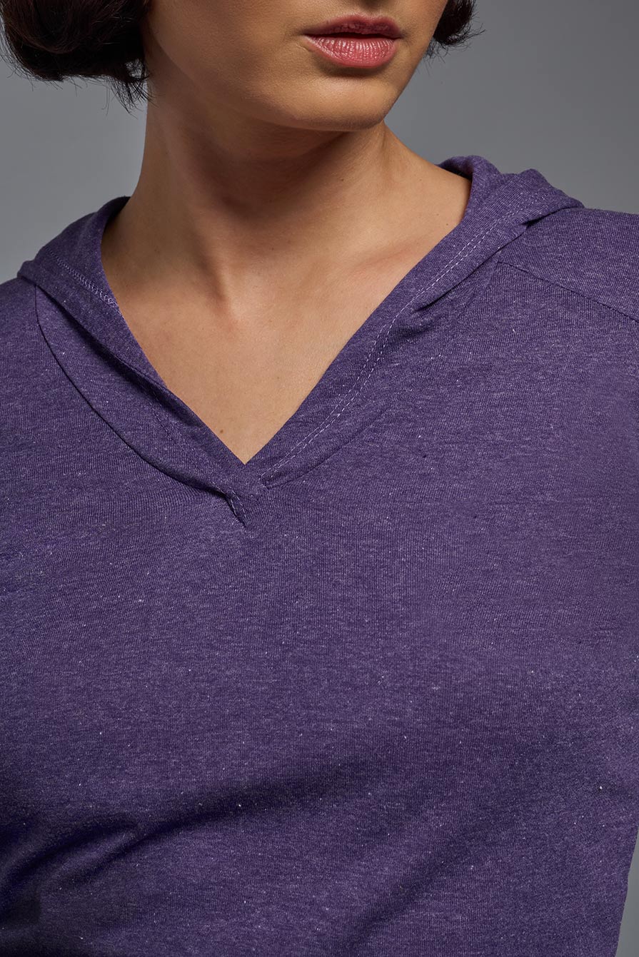 A female model wearing the women's Heather Hoodie Shirt in the color dark heather purple, showing the modern fit from a closeup collar front view. This hoodie shirt is made in the USA. #color_dark-heather-purple