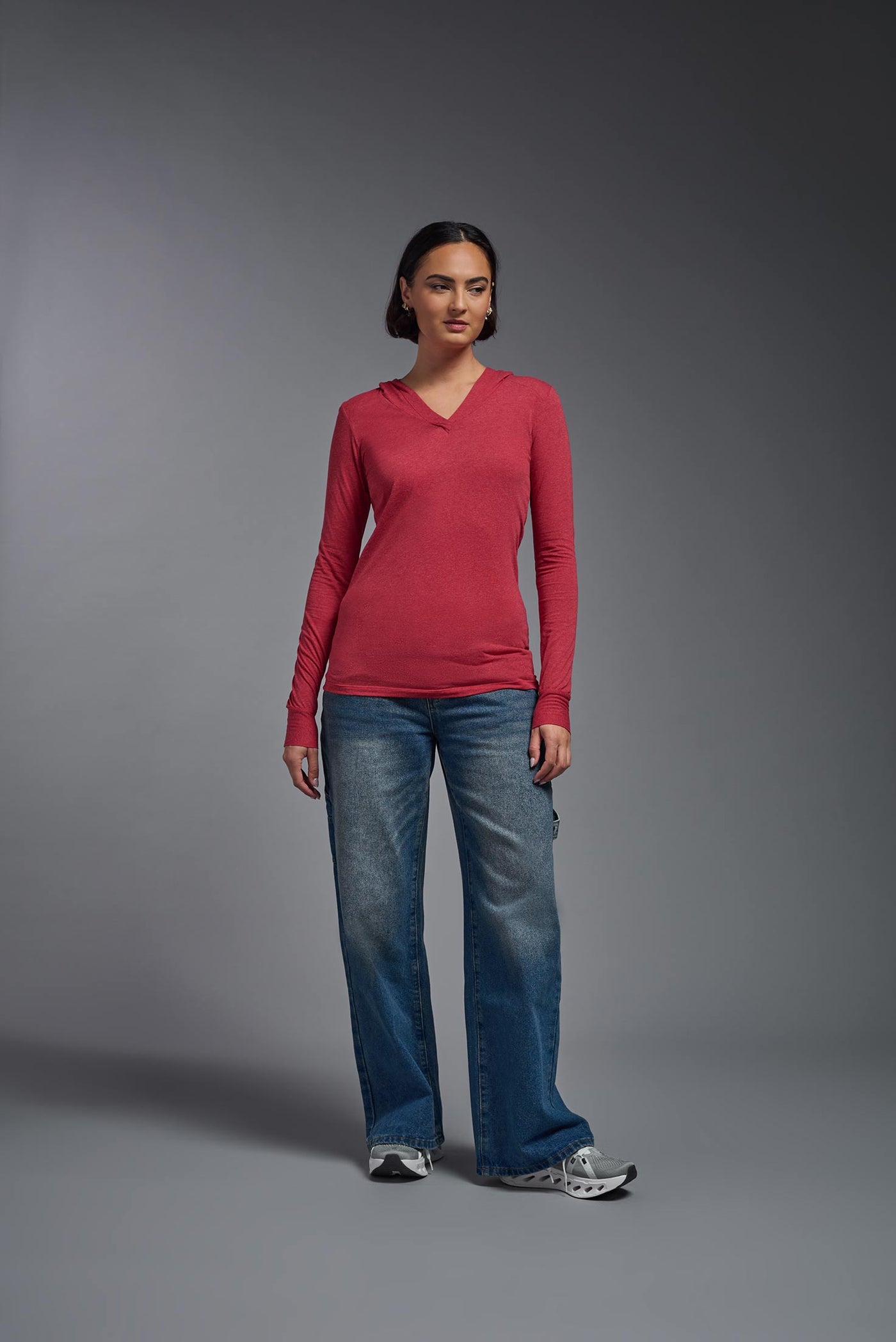 A female model wearing the women's Heather Hoodie Shirt in the color dark heather red, showing the modern fit from a front view. This hoodie shirt is made in the USA. #color_dark-heather-red