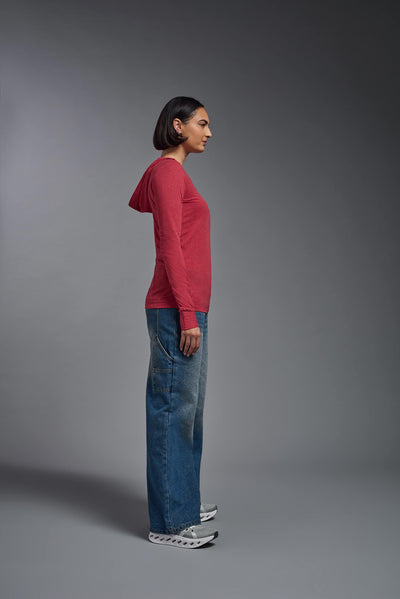 A female model wearing the women's Heather Hoodie Shirt in the color dark heather red, showing the modern fit from a side view. This hoodie shirt is made in the USA. #color_dark-heather-red