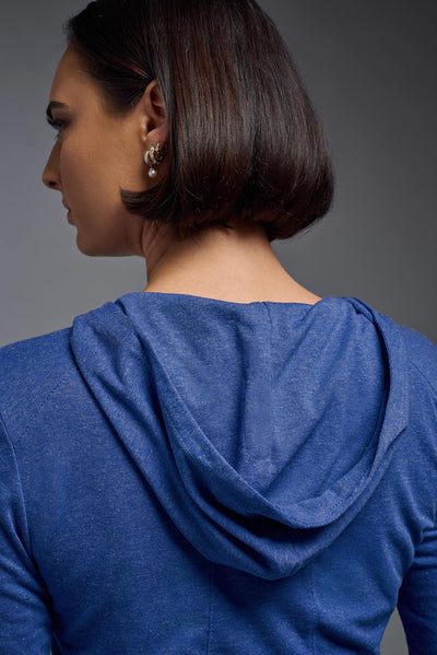 A female model wearing the women's Heather Hoodie Shirt in the color dark heather royal blue, showing the modern fit from a closeup hoodie back view. This hoodie shirt is made in the USA. #color_dark-heather-royal
