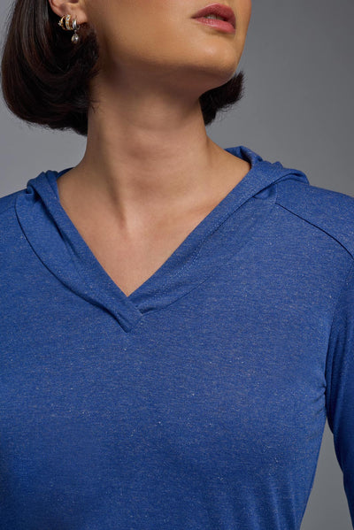 A female model wearing the women's Heather Hoodie Shirt in the color dark heather royal blue, showing the modern fit from a closeup v-neck collar view. This hoodie shirt is made in the USA. #color_dark-heather-royal