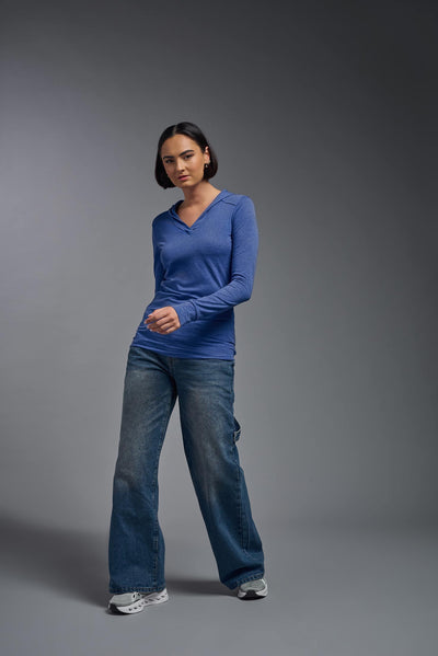 A female model wearing the women's Heather Hoodie Shirt in the color dark heather royal blue, showing the modern fit from a front view. This hoodie shirt is made in the USA. #color_dark-heather-royal