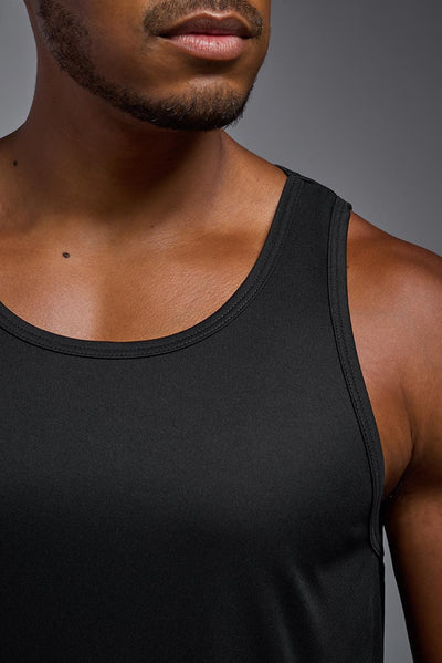 An African American male model with a beard on a gray background, wearing the Men's DriMax Endurance Tank in the color black from a closeup collar front view. This shirt is made in the USA and is quick-drying and moisture-wicking. #color_black