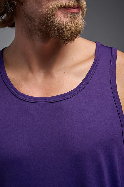 A blonde male model with a beard on a gray background, wearing the Men's DriMax Endurance Tank in the color dark purple from a closeup collar front view. This shirt is made in the USA and is quick-drying and moisture-wicking. #color_dark-purple