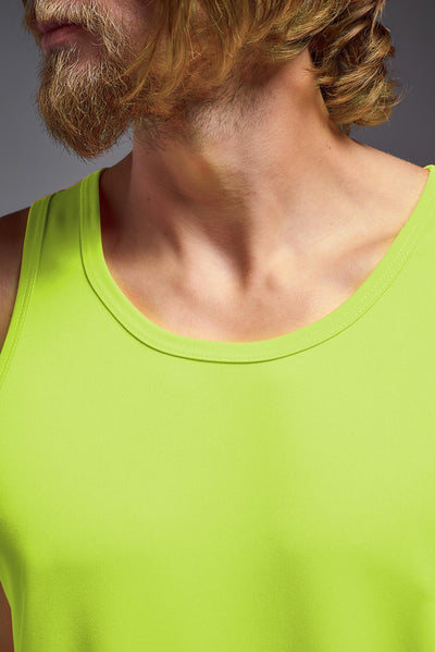 A blonde male model with a beard on a gray background, wearing the Men's DriMax Endurance Tank in the color safety yellow from a closeup front collar view. This shirt is made in the USA and is quick-drying and moisture-wicking. #color_safety-yellow