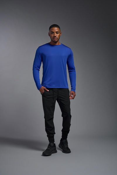 An African American male model with a beard on a gray background, wearing the Men's DriMax Long Sleeve Expert Shirt in the color royal blue from a full body front view. This shirt is made in the USA and is quick-drying and moisture-wicking. #color_royal-blue