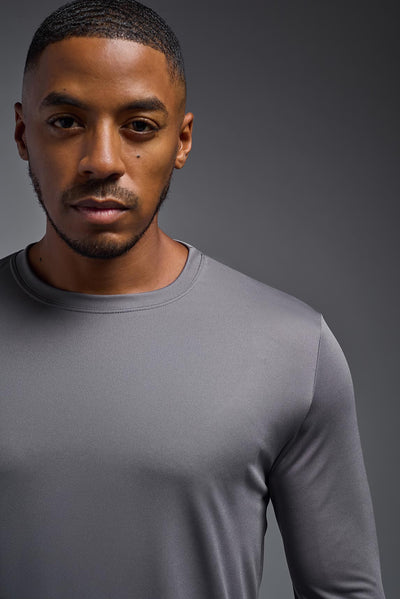 An African American male model with a beard on a gray background, wearing the Men's DriMax Long Sleeve Expert Shirt in the color steel from a close-up collar view. This shirt is made in the USA and is quick-drying and moisture-wicking. #color_steel