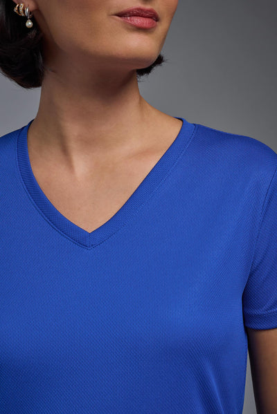 A female model with brown short hair on a gray background, wearing the Women's Oxymesh™ V-neck Tech Tee in the color royal blue from a closeup collar front view. This shirt is made in the USA and is quick-drying and moisture-wicking. #color_royal-blue