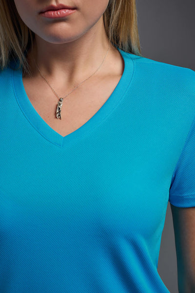 A blonde female model with long straight hair on a gray background, wearing the Women's Oxymesh™ V-neck Tech Tee in the color turquoise from a closeup collar front view. This shirt is made in the USA and is quick-drying and moisture-wicking. #color_turquoise