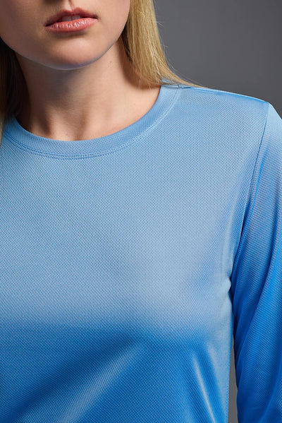 A blonde, female model with long straight hair on a gray background, wearing the Women's Oxymesh™ Long Sleeve Tech Tee in the color carolina blue from a closeup collar front view. This shirt is made in the USA and is quick-drying and moisture-wicking. #color_carolina-blue