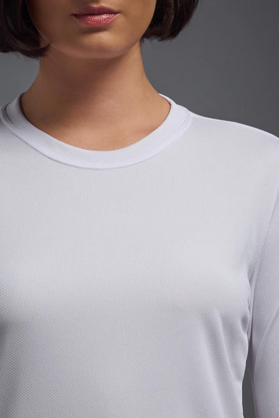 A female model with short brown hair on a gray background, wearing the Women's Oxymesh™ Long Sleeve Tech Tee in the color white from a closeup collar front view. This shirt is made in the USA and is quick-drying and moisture-wicking. #color_white