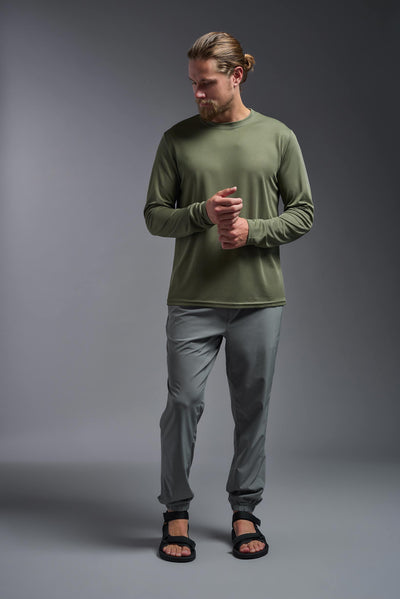 A blonde Caucasian male model with a beard wearing the men's Oxymesh Long Sleeve Tech Tee in the color key lime on a gray background, made out of 100% polyester, showing the relaxed fit from a full body front view. This shirt is breathable, quick-drying, moisture-wicking, and made in the USA. #color_military-green