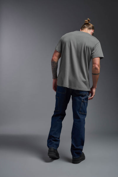 A male caucasian model with a beard wearing the men's DuroSoft Outdoor Tee in the color army gray on a gray background, made out of 100% filament polyester that feels like soft cotton, showing the modern fit from a back view. This shirt is anti-snagging, quick-drying and moisture-wicking and is made in the USA. #color_army-gray