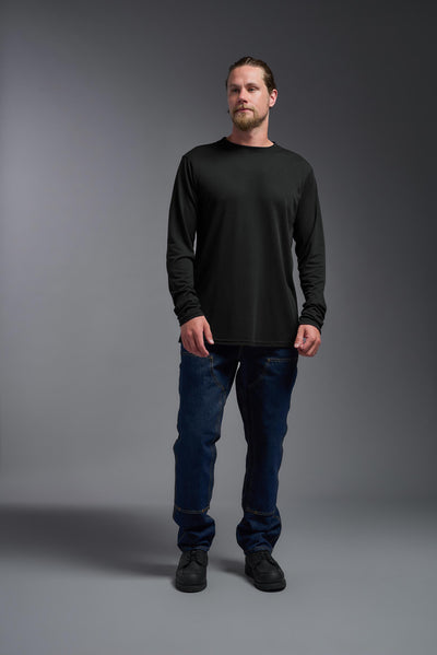 A male Caucasian model with a blonde hair and a beard wearing the men's DuroSoft Outdoor Long Sleeve in the color black on a gray background, made out of 100% filament polyester that feels like soft cotton, showing the modern fit from a front view. This shirt is anti-snagging, quick-drying and moisture-wicking and is made in the USA. #color_black