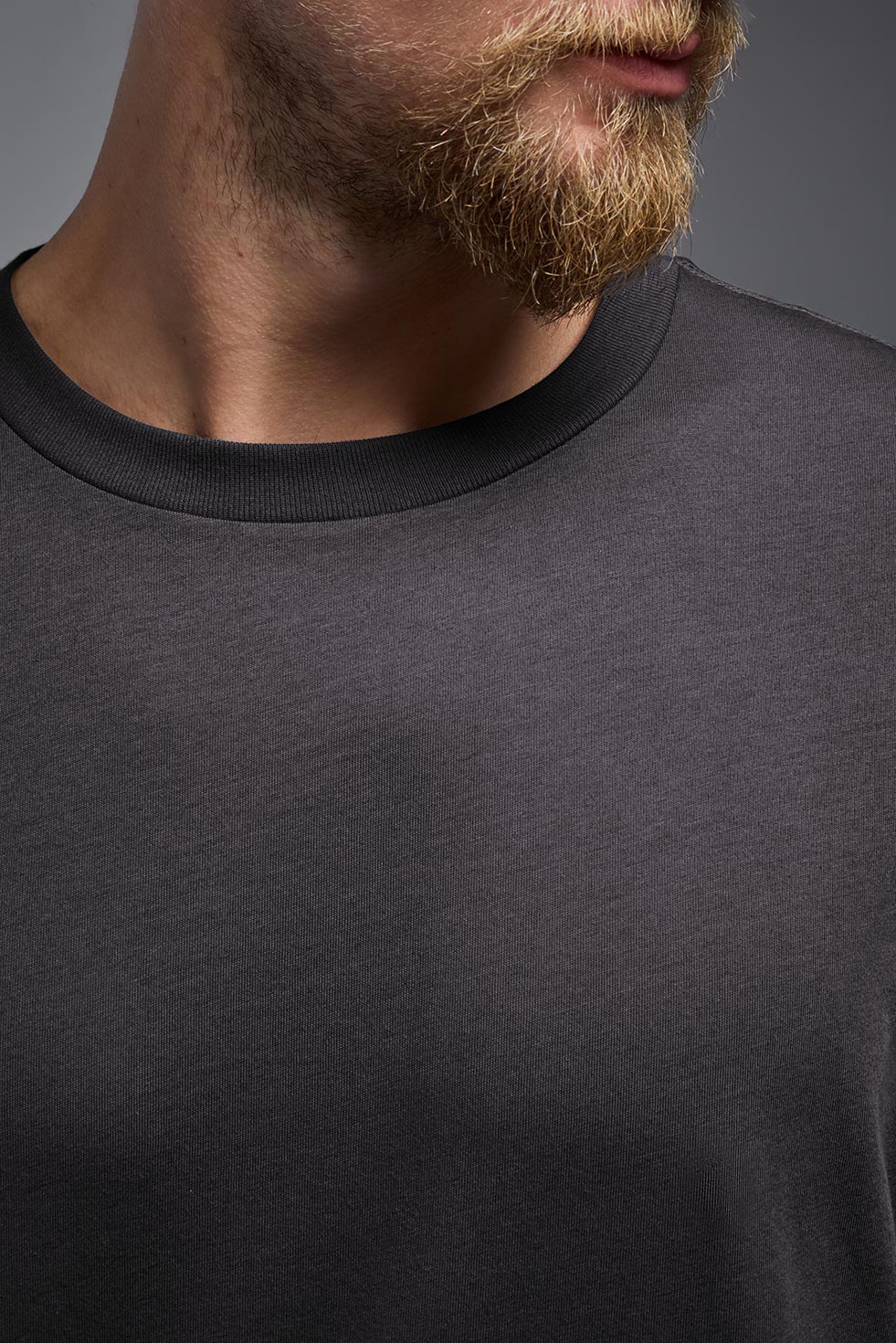 A male and female model wearing the unisex Organic Soft Cotton T-shirt in the color nova, made from 100% certified organic cotton, shot from a closeup collar front view. This shirt is unisex and made in the USA. #color_carbon