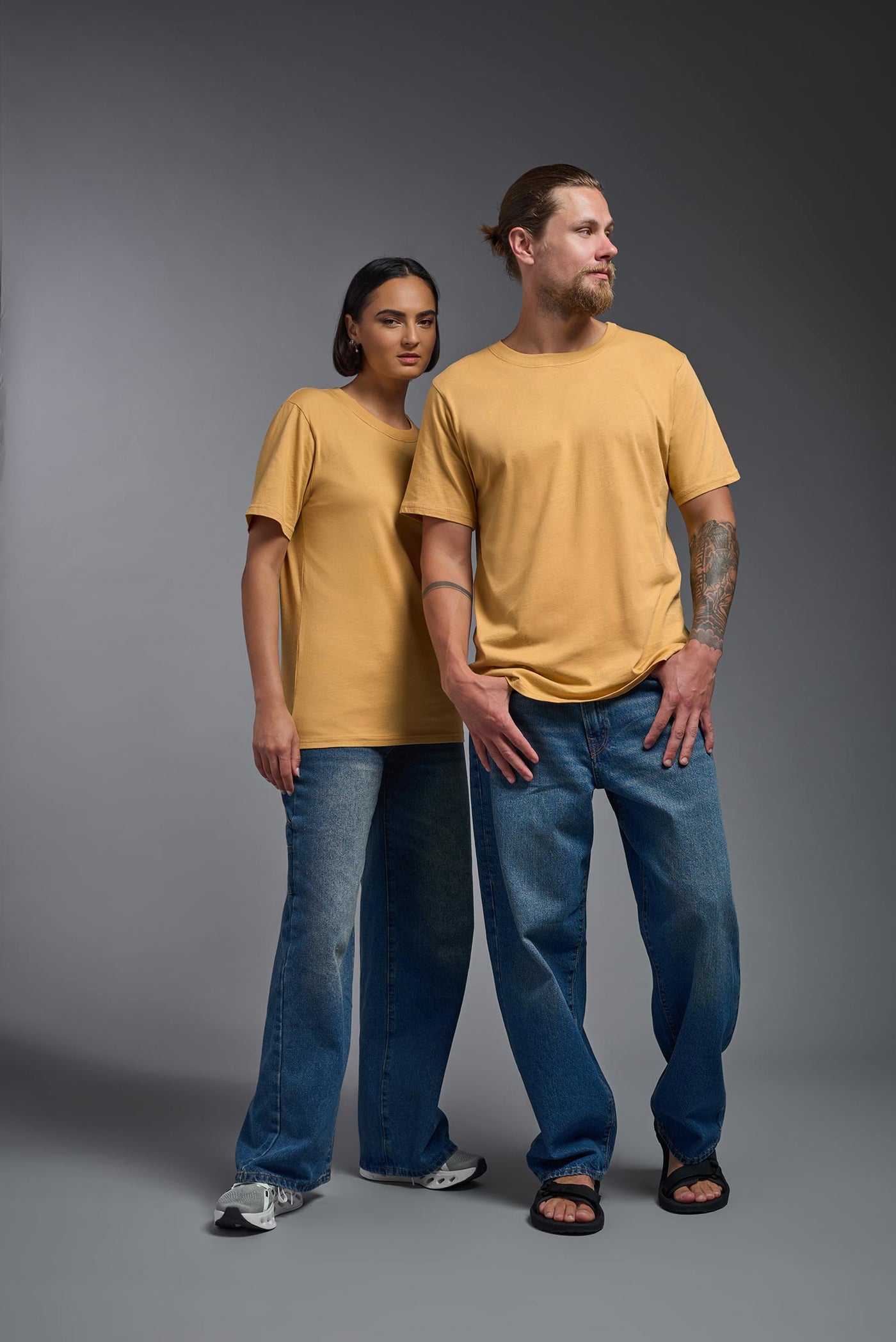 A male and female model wearing the unisex Organic Soft Cotton T-shirt in the color harvest, made from 100% certified organic cotton, shot from a full body front view. This shirt is unisex and made in the USA. #color_harvest