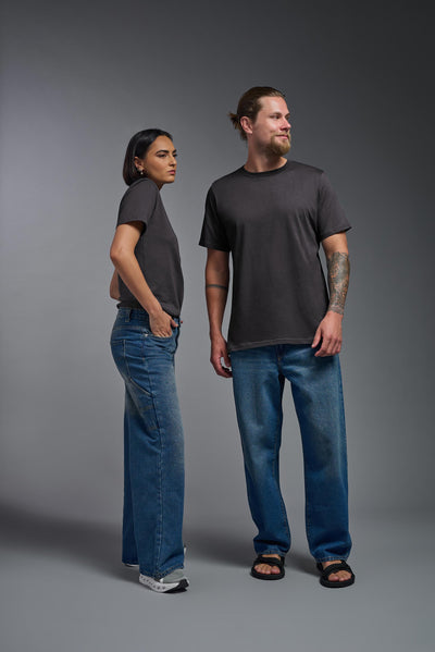 A male and female model wearing the unisex Organic Soft Cotton T-shirt in the color nova, made from 100% certified organic cotton, shot from a full body front view. This shirt is unisex and made in the USA. #color_carbon