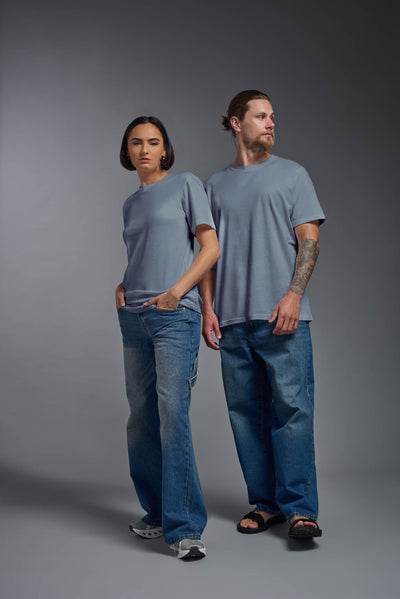 A male and female model wearing the unisex Organic Soft Cotton T-shirt in the color canyon blue, made from 100% certified organic cotton, shot from a full body front view. This shirt is unisex and made in the USA. #color_canyon-blue
